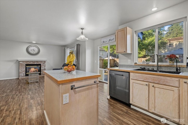 20111 74th Avenue Ct E, Spanaway, WA 98387 - kitchen featuring light brown cabinetry, dishwasher, a sink, a brick fireplace, and a kitchen island