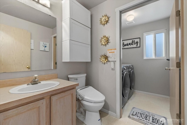 20111 74th Avenue Ct E, Spanaway, WA 98387 - bathroom with independent washer and dryer, toilet, vanity, and baseboards