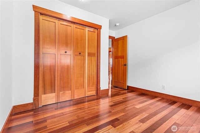 3276 Spyglass Dr, Bellingham, WA 98226 - unfurnished bedroom featuring wood finished floors, baseboards, and a closet