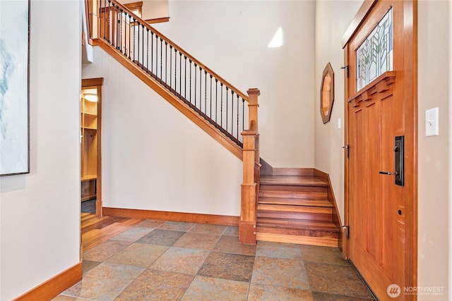 3276 Spyglass Dr, Bellingham, WA 98226 - entryway with baseboards, stone tile floors, stairs, and a high ceiling