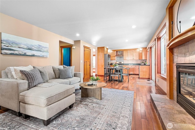 3276 Spyglass Dr, Bellingham, WA 98226 - living room with light wood-type flooring, recessed lighting, a tile fireplace, and baseboards