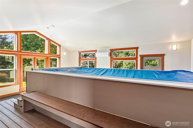 3276 Spyglass Dr, Bellingham, WA 98226 - miscellaneous room with a wall mounted air conditioner, wood finished floors, and lofted ceiling