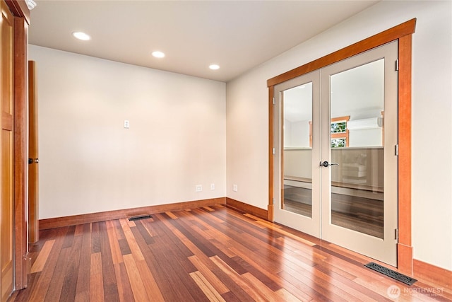 3276 Spyglass Dr, Bellingham, WA 98226 - spare room featuring french doors, wood-type flooring, baseboards, and recessed lighting