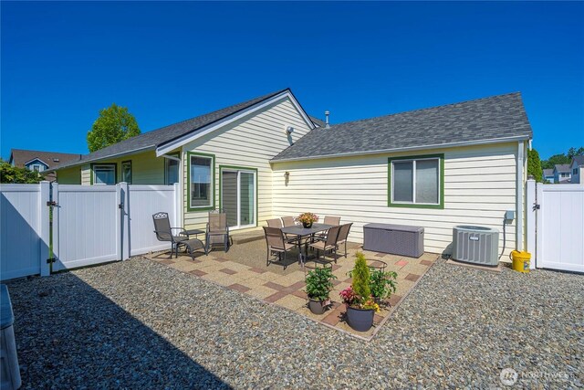 1936 Palisade Blvd, Dupont, WA 98327 - rear view of house featuring a gate, central air condition unit, roof with shingles, a fenced backyard, and a patio