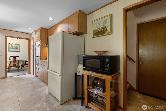7425 S Alaska St, Tacoma, WA 98408 - kitchen featuring freestanding refrigerator, black microwave, crown molding, a chandelier, and double wall oven