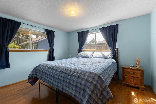 7425 S Alaska St, Tacoma, WA 98408 - bedroom with wood finished floors, a textured ceiling, and baseboards