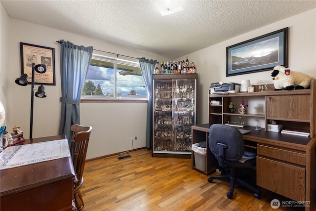 7425 S Alaska St, Tacoma, WA 98408 - home office with light wood-type flooring and a textured ceiling