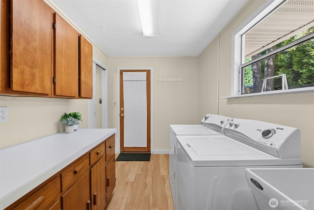 20608 1st Ave S, Des Moines, WA 98198 - laundry room with independent washer and dryer, light wood-type flooring, and cabinet space