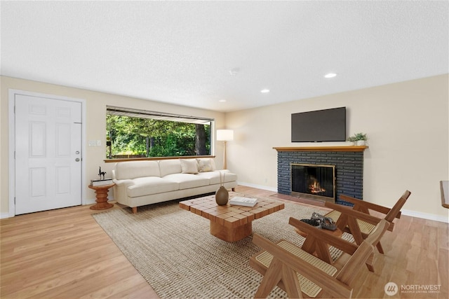 20608 1st Ave S, Des Moines, WA 98198 - living room with a fireplace, light wood-type flooring, baseboards, and recessed lighting