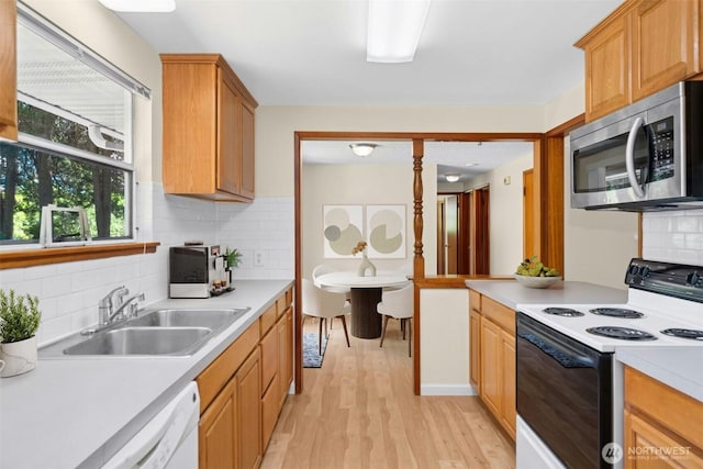 20608 1st Ave S, Des Moines, WA 98198 - kitchen featuring electric range, stainless steel microwave, a sink, and light countertops
