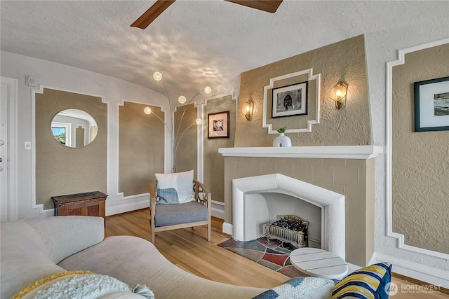1101 17th Ave Unit 403, Seattle, WA 98122 - living area featuring ceiling fan, a textured wall, wood finished floors, a textured ceiling, and vaulted ceiling