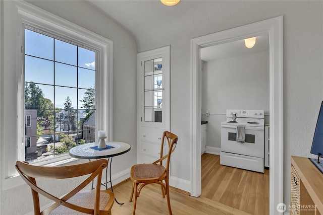 1101 17th Ave Unit 403, Seattle, WA 98122 - dining room featuring plenty of natural light, light wood-type flooring, and baseboards