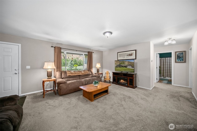 6132 Entiat River Rd, Entiat, WA 98822 - living room featuring baseboards, carpet floors, and a warm lit fireplace