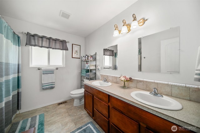 6132 Entiat River Rd, Entiat, WA 98822 - bathroom featuring healthy amount of natural light, double vanity, toilet, and baseboards