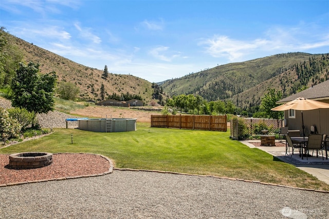 6132 Entiat River Rd, Entiat, WA 98822 - view of yard with an outdoor fire pit, a mountain view, and a patio