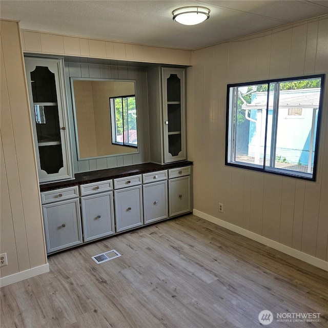 7031 NE 175th St Unit 20, Kenmore, WA 98028 - empty room with light wood-type flooring, baseboards, and wood walls