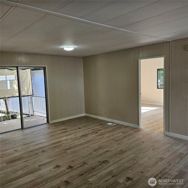 7031 NE 175th St Unit 20, Kenmore, WA 98028 - unfurnished room featuring wood finished floors, wooden walls, and baseboards