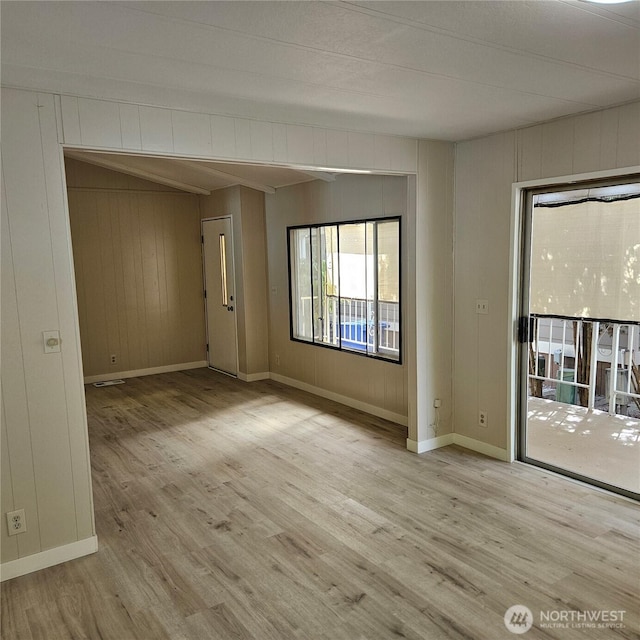 7031 NE 175th St Unit 20, Kenmore, WA 98028 - empty room with wood finished floors, wood walls, and baseboards