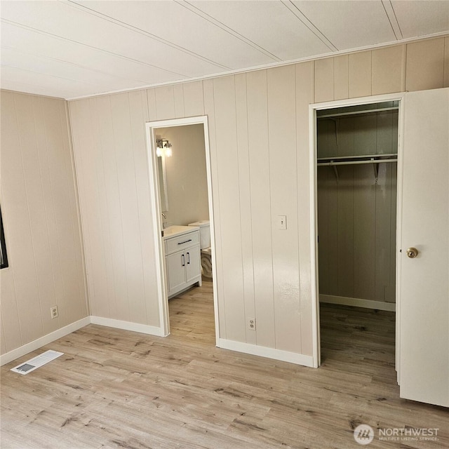 7031 NE 175th St Unit 20, Kenmore, WA 98028 - unfurnished bedroom with a closet, light wood-style floors, a spacious closet, and baseboards