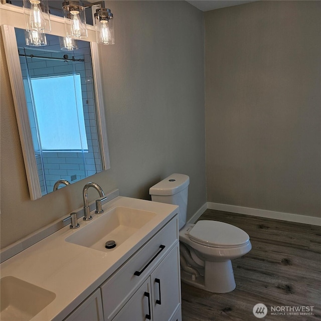 7031 NE 175th St Unit 20, Kenmore, WA 98028 - bathroom with double vanity, toilet, wood finished floors, and baseboards