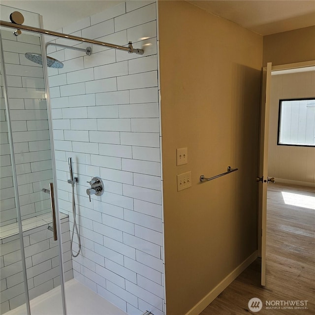 7031 NE 175th St Unit 20, Kenmore, WA 98028 - bathroom with wood finished floors, a stall shower, and baseboards