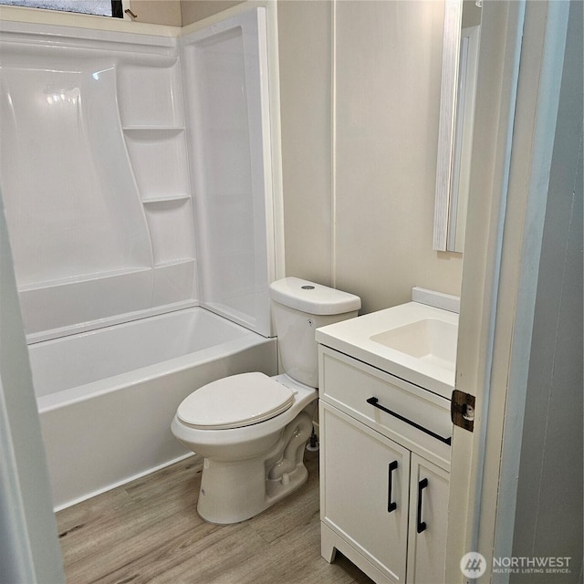 7031 NE 175th St Unit 20, Kenmore, WA 98028 - bathroom featuring vanity, wood finished floors, toilet, and tub / shower combination