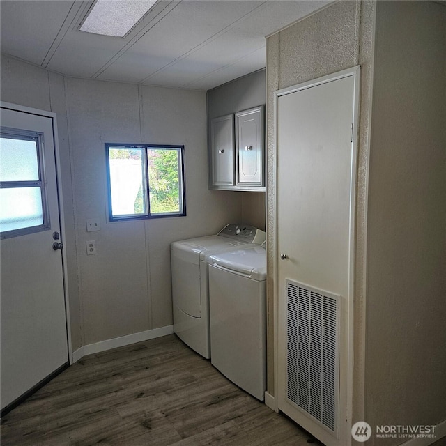 7031 NE 175th St Unit 20, Kenmore, WA 98028 - laundry area with cabinet space, independent washer and dryer, wood finished floors, and baseboards