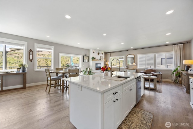 9968 Griffith Pl, Entiat, WA 98822 - kitchen with a sink, stainless steel dishwasher, recessed lighting, white cabinetry, and light wood finished floors