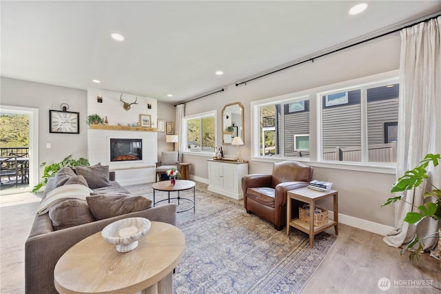 9968 Griffith Pl, Entiat, WA 98822 - living area featuring recessed lighting, baseboards, a glass covered fireplace, and wood finished floors