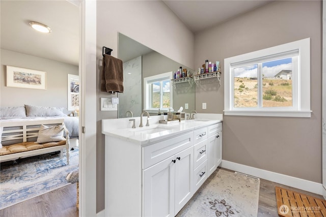 9968 Griffith Pl, Entiat, WA 98822 - bathroom with double vanity, wood finished floors, baseboards, and ensuite bath