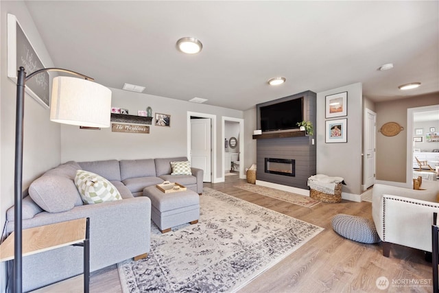 9968 Griffith Pl, Entiat, WA 98822 - living area featuring a fireplace, wood finished floors, and baseboards