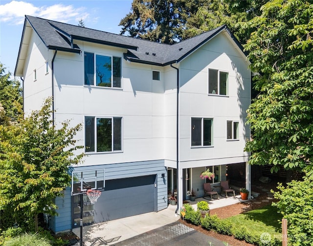 2736 SW Holden St, Seattle, WA 98126 - view of front facade with driveway, a garage, a shingled roof, and a porch