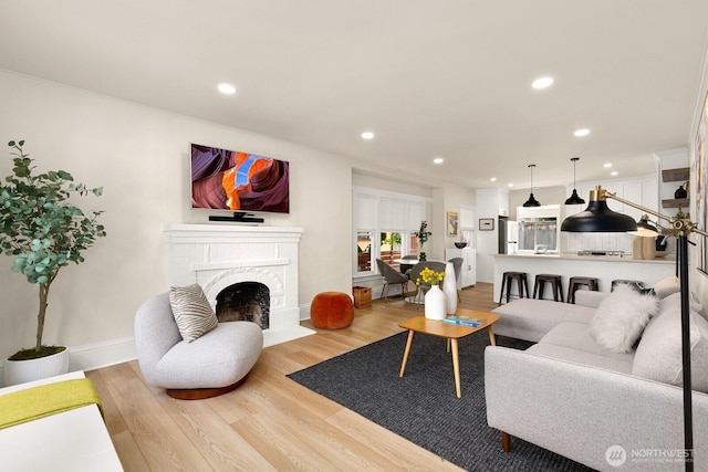 4607 1st Ave NE, Seattle, WA 98105 - living area with recessed lighting, light wood-style flooring, a fireplace, crown molding, and baseboards