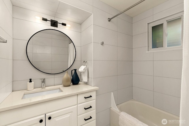 4607 1st Ave NE, Seattle, WA 98105 - full bathroom featuring vanity, washtub / shower combination, and tile walls