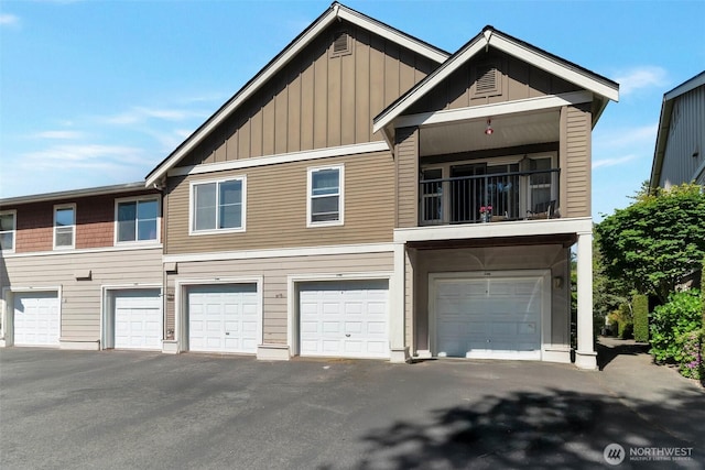 2198 Palisade Blvd Unit C2, Dupont, WA 98372 - view of front of house with board and batten siding, an attached garage, and a balcony