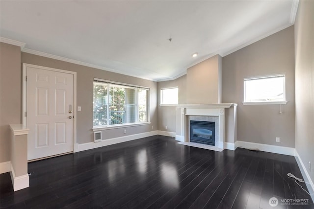 2198 Palisade Blvd Unit C2, Dupont, WA 98372 - unfurnished living room with baseboards, dark wood-type flooring, ornamental molding, and a tiled fireplace