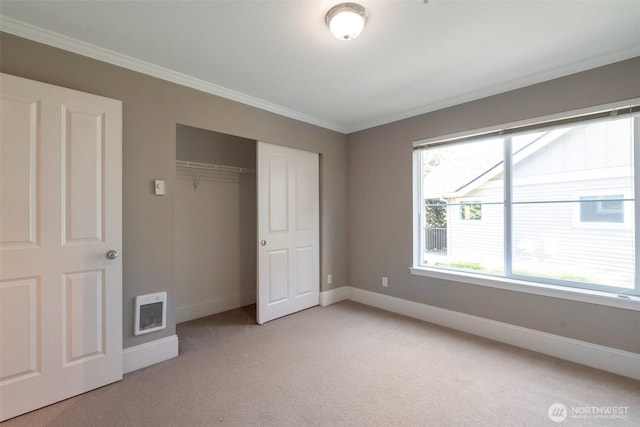 2198 Palisade Blvd Unit C2, Dupont, WA 98372 - unfurnished bedroom featuring light carpet, baseboards, crown molding, and a closet