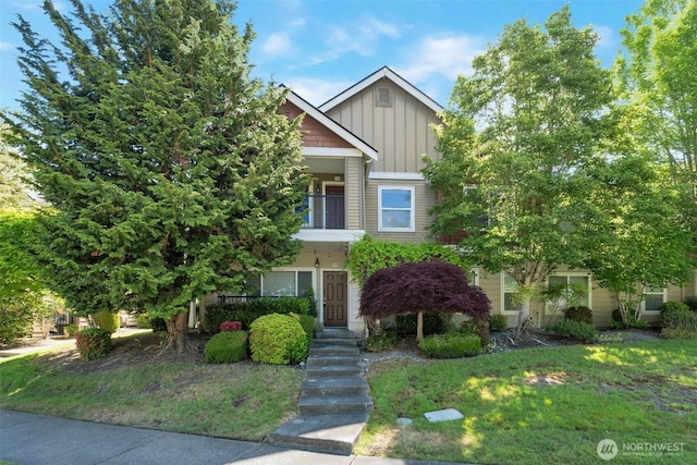 2198 Palisade Blvd Unit C2, Dupont, WA 98372 - view of front of house with board and batten siding, a balcony, and a front yard
