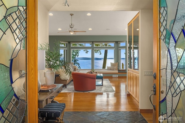 2 Edgewater Dr, Camano Island, WA 98282 - entrance foyer featuring a water view, wood finished floors, a ceiling fan, and recessed lighting