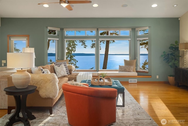 2 Edgewater Dr, Camano Island, WA 98282 - living area featuring plenty of natural light, a water view, wood finished floors, recessed lighting, and ceiling fan