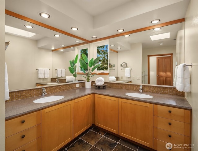 2 Edgewater Dr, Camano Island, WA 98282 - bathroom featuring a skylight, double vanity, backsplash, recessed lighting, and tile patterned floors