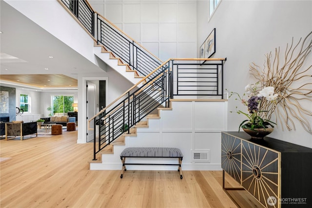 12811 SE 44th Pl, Bellevue, WA 98006 - staircase featuring a high ceiling, wood finished floors, and recessed lighting