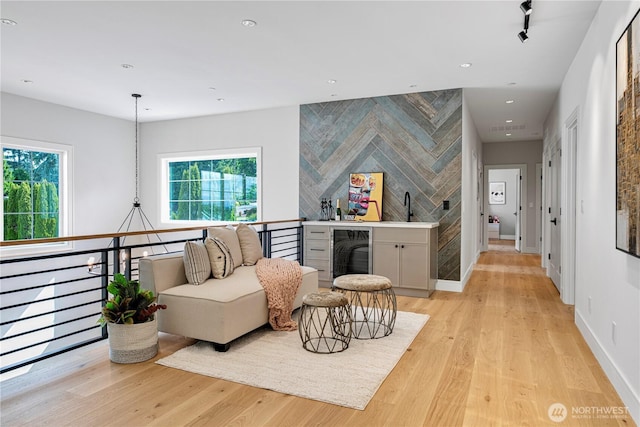 12811 SE 44th Pl, Bellevue, WA 98006 - sitting room with light wood finished floors, beverage cooler, recessed lighting, and baseboards