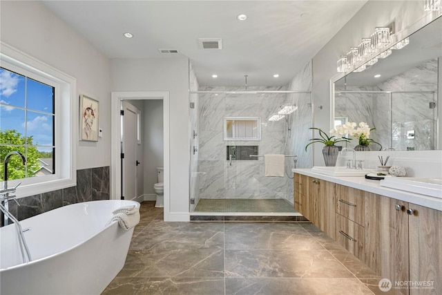 12811 SE 44th Pl, Bellevue, WA 98006 - full bathroom featuring marble look tile flooring, a marble finish shower, a soaking tub, vanity, and recessed lighting