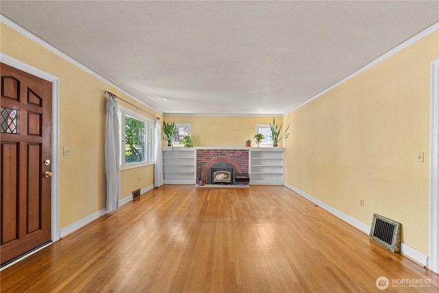 912 Highland Dr, Wenatchee, WA 98801 - unfurnished living room with light wood-type flooring, baseboards, and crown molding