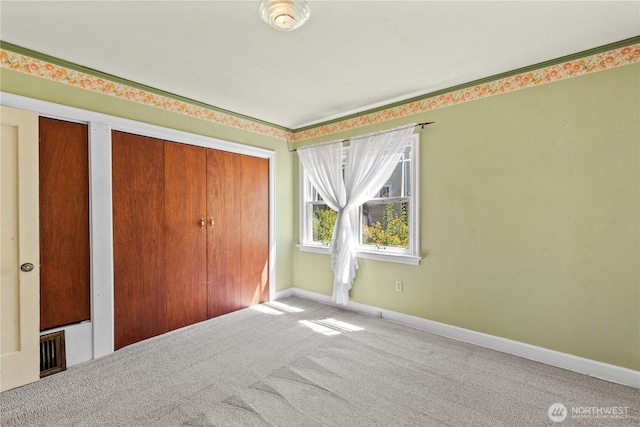912 Highland Dr, Wenatchee, WA 98801 - unfurnished bedroom with carpet, baseboards, and multiple closets