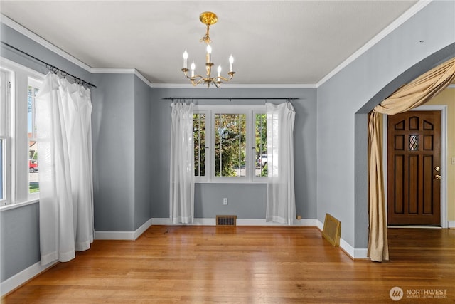 912 Highland Dr, Wenatchee, WA 98801 - unfurnished dining area with a chandelier, wood finished floors, baseboards, and crown molding