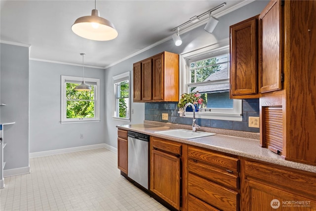 912 Highland Dr, Wenatchee, WA 98801 - kitchen featuring stainless steel dishwasher, a sink, decorative backsplash, baseboards, and ornamental molding