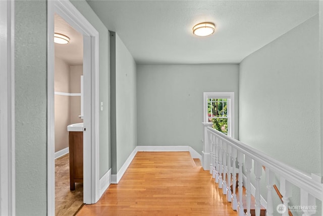 912 Highland Dr, Wenatchee, WA 98801 - hallway with light wood finished floors, baseboards, and an upstairs landing