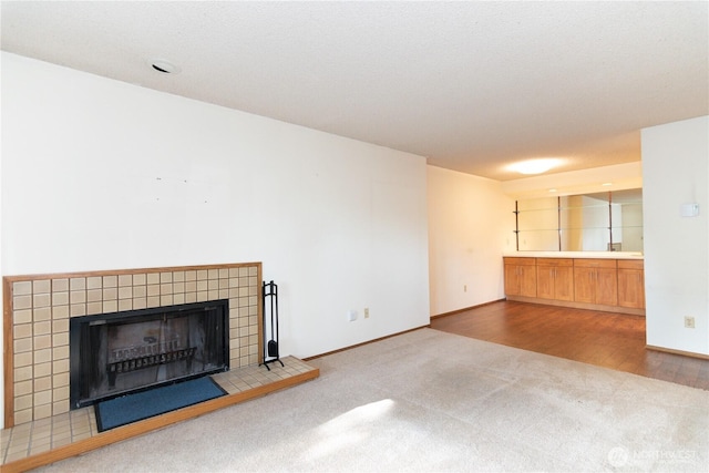 3421 SW Roxbury St Unit 106, Seattle, WA 98126 - unfurnished living room with carpet floors, a fireplace, and baseboards